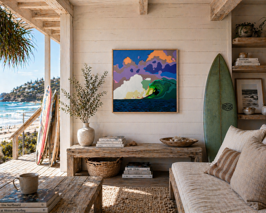 Living room with ocean view, surfboard, and artwork on a wooden wall.