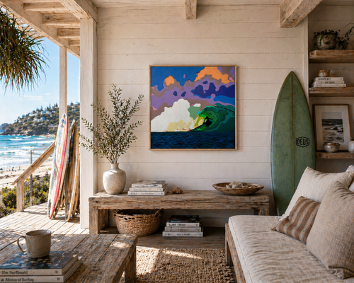 Living room with ocean view, surfboard, and artwork on a wooden wall.
